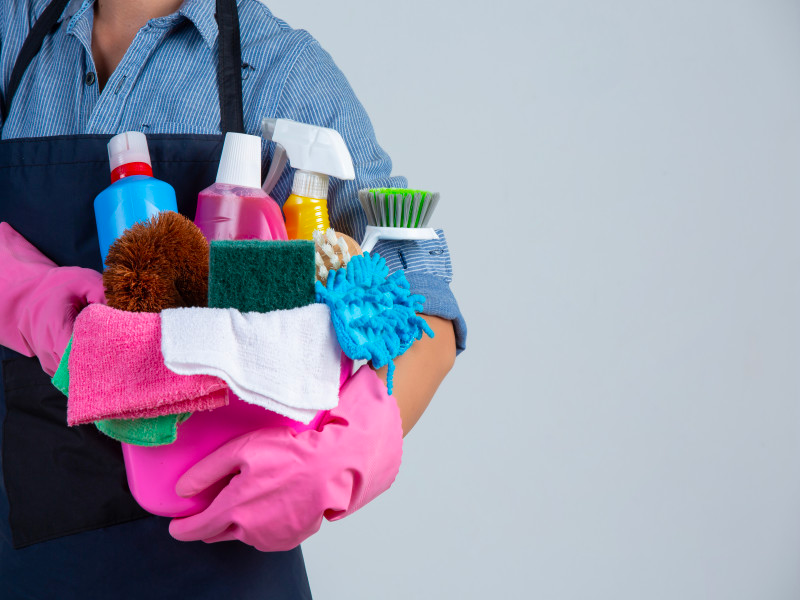 a maid with cleaning supplies