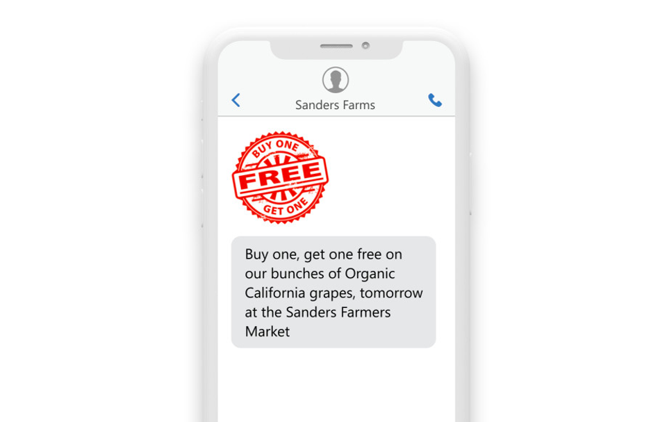 a phone with the message: “Buy one, get one free on our bunches of Organic California grapes, tomorrow at the Sanders Farmers Market.”