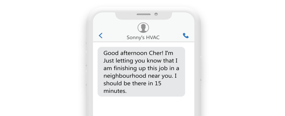 an sms on a phone reading: “Good afternoon Cher! I’m just finishing up a job in a neighborhood near you. I should be there in 15 minutes.”