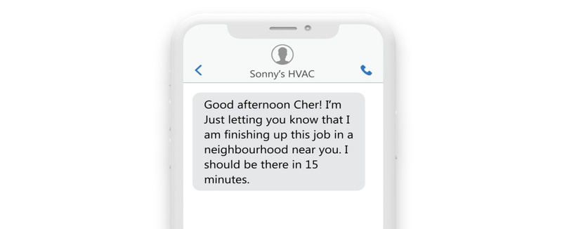 an sms on a phone reading: “Good afternoon Cher! I’m just finishing up a job in a neighborhood near you. I should be there in 15 minutes.” an sms on a phone reading: “Good afternoon Cher! I’m just finishing up a job in a neighborhood near you. I should be there in 15 minutes.”