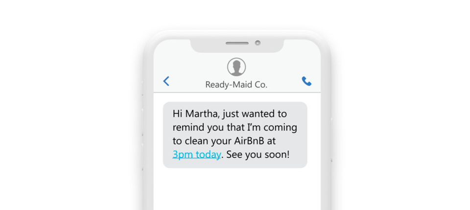 a phone showing a text reading: “Hi Martha, Just wanted to remind you that I am coming in to clean your AirBnb at 3pm today. See you soon!”