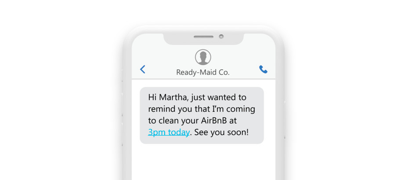 a phone showing a text reading: “Hi Martha, Just wanted to remind you that I am coming in to clean your AirBnb at 3pm today. See you soon!” a phone showing a text reading: “Hi Martha, Just wanted to remind you that I am coming in to clean your AirBnb at 3pm today. See you soon!”