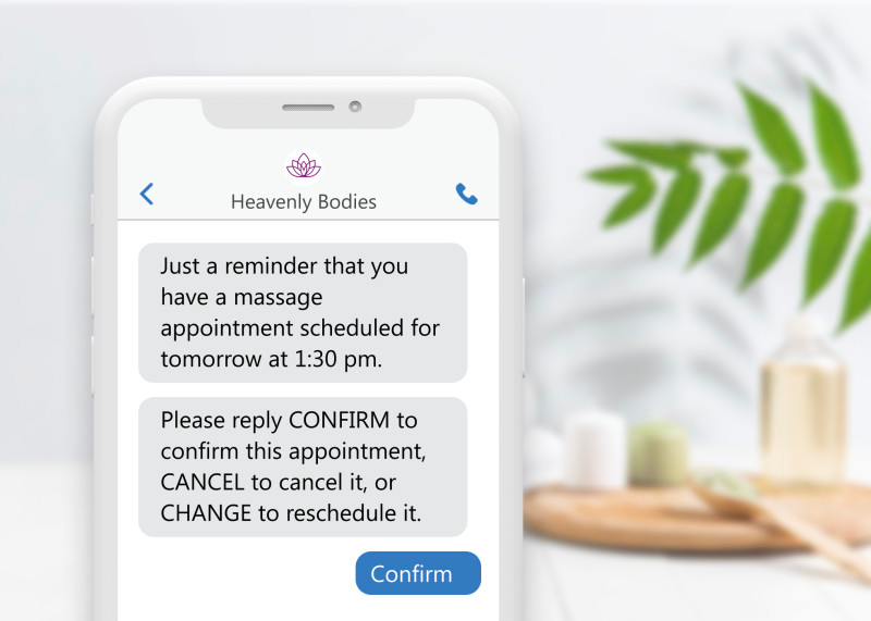a picture of a phone with a spa background. the phone shows messages about a reminder for an appointment and to reply CONFIRM or CANCEL