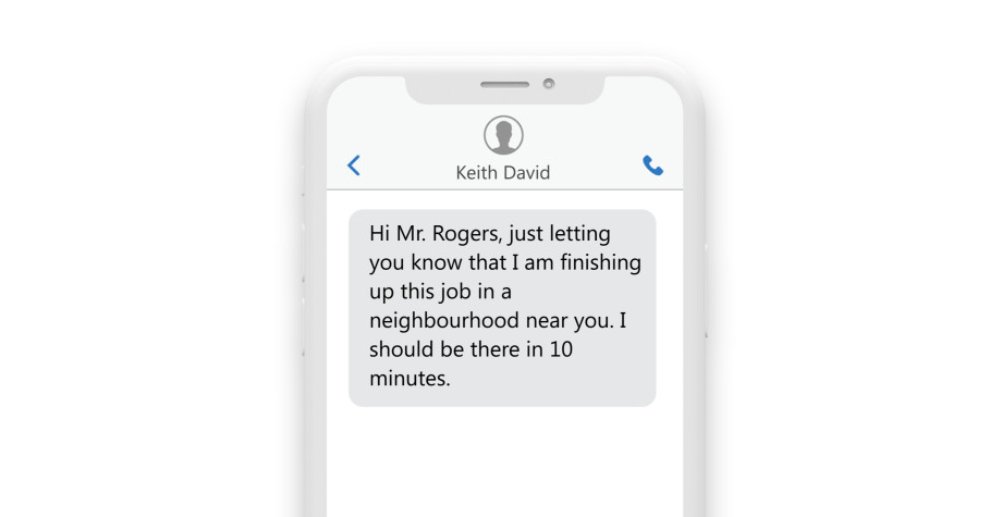 a phone showing a text: “Hey Mr. Rogers, Just wanted you to know that I am just finishing up a job in a neighborhood near you and I should be there in 10 minutes.”