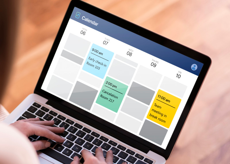 a picture of a laptop with a screenshot of txtsquad's calendar with booked meetings
