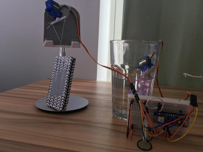 Photo of the previous version of the instrument, using servo motors making sounds in water cups