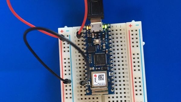 Photo of an Arduino Nano 33 IoT connected to USB and a breadboard