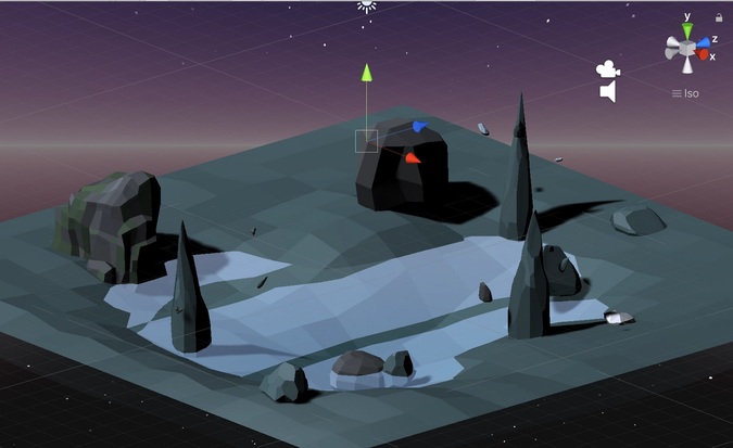 Screen capture of Unity depicting a 3d scene with various rocks surrounding a pond