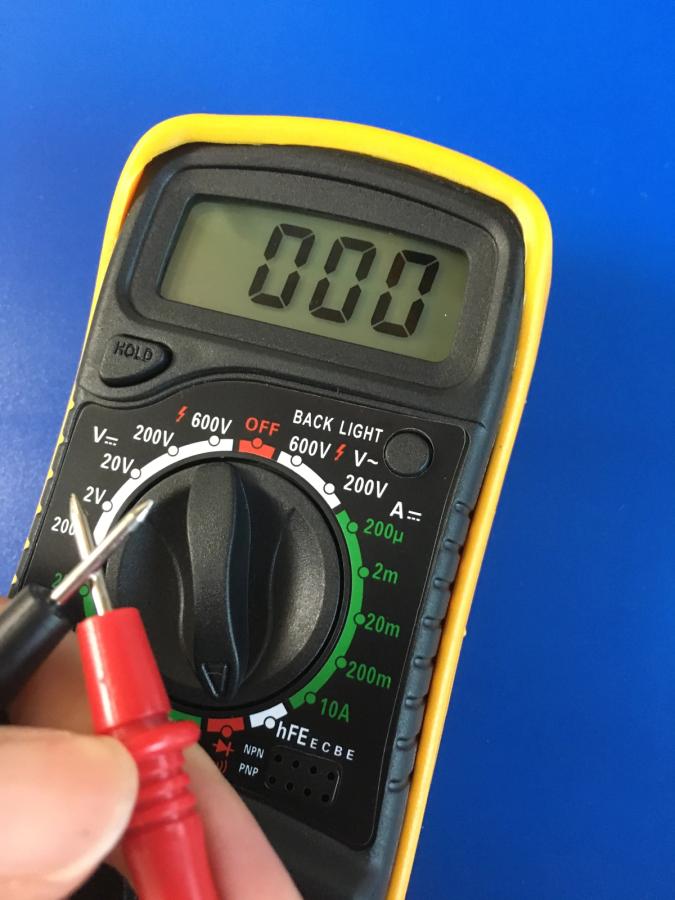 Photo of a multimeter with two probes crossed