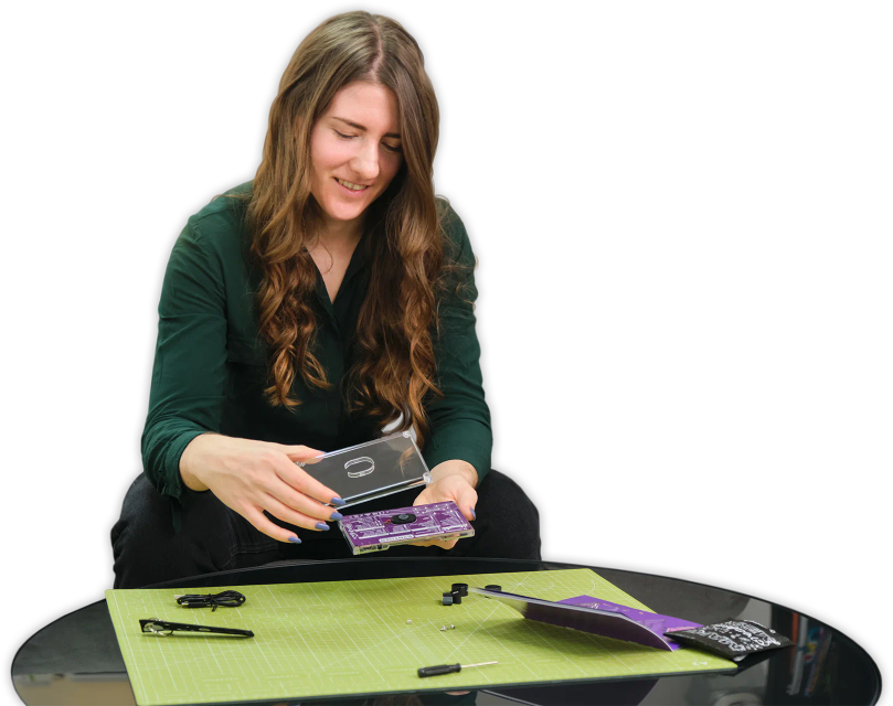 A woman assembling CircuitMess Synthia 2.0