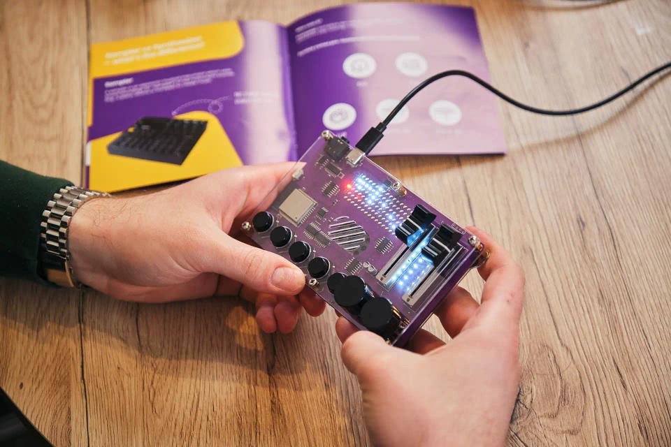 A person holding CircuitMess Synthia