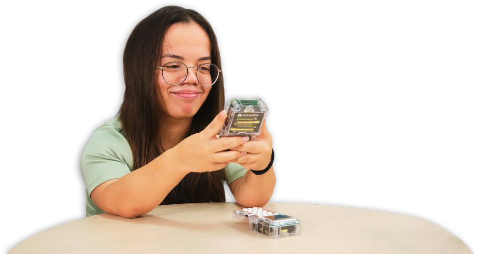 A woman texting on a CircuitMess Chatter 2.0.
