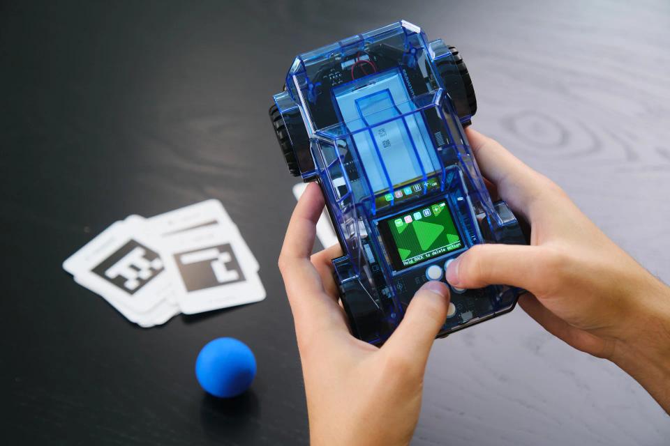 A person playing with CircuitMess Wheelson 2.0.