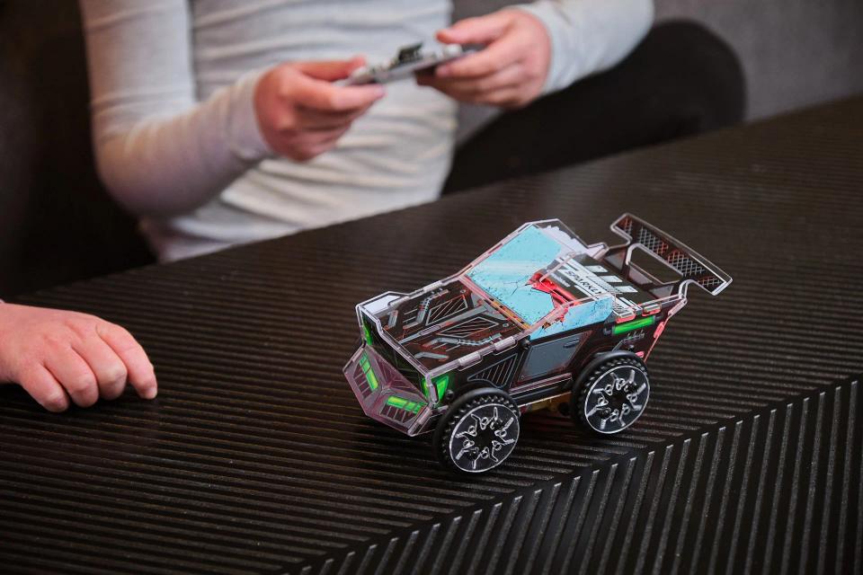 A person playing with CircuitMess Sparkly using its controller