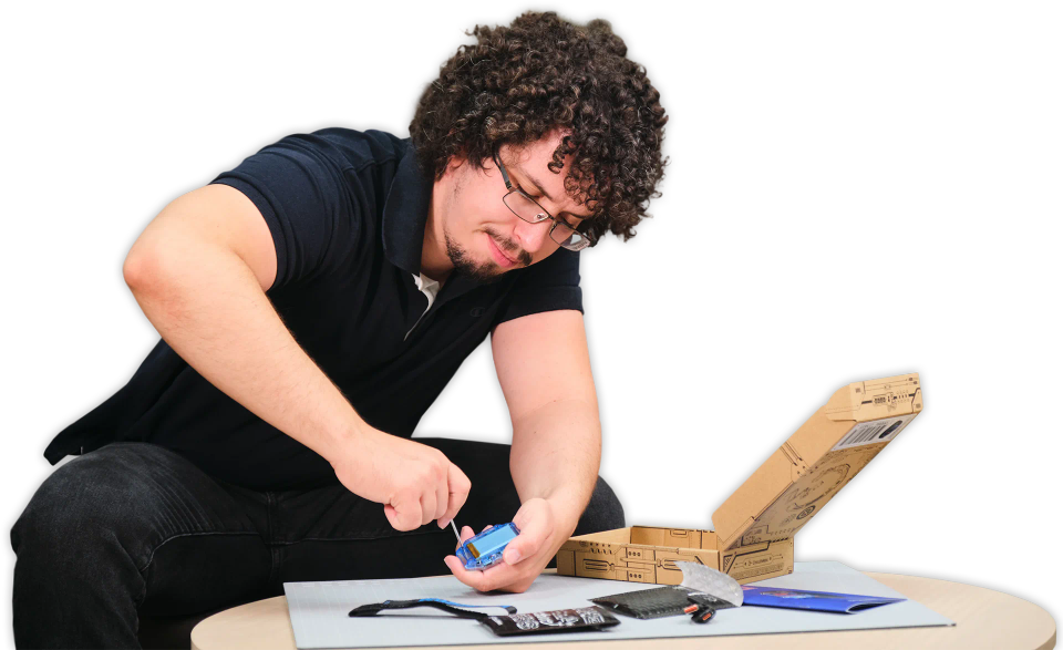 A man assembling CircuitMess Clockstar 2.0.