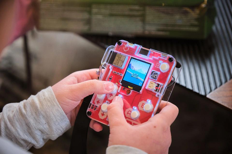 A person playing with CircuitMess Bit and playing Sparkly game