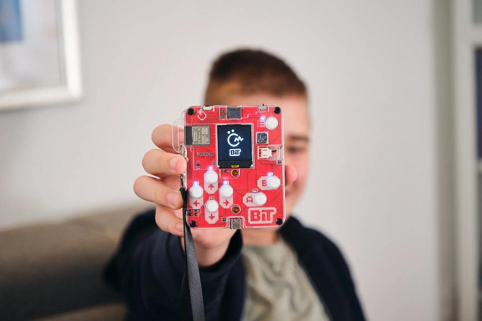 A boy showing an assembled CircuitMess Bit