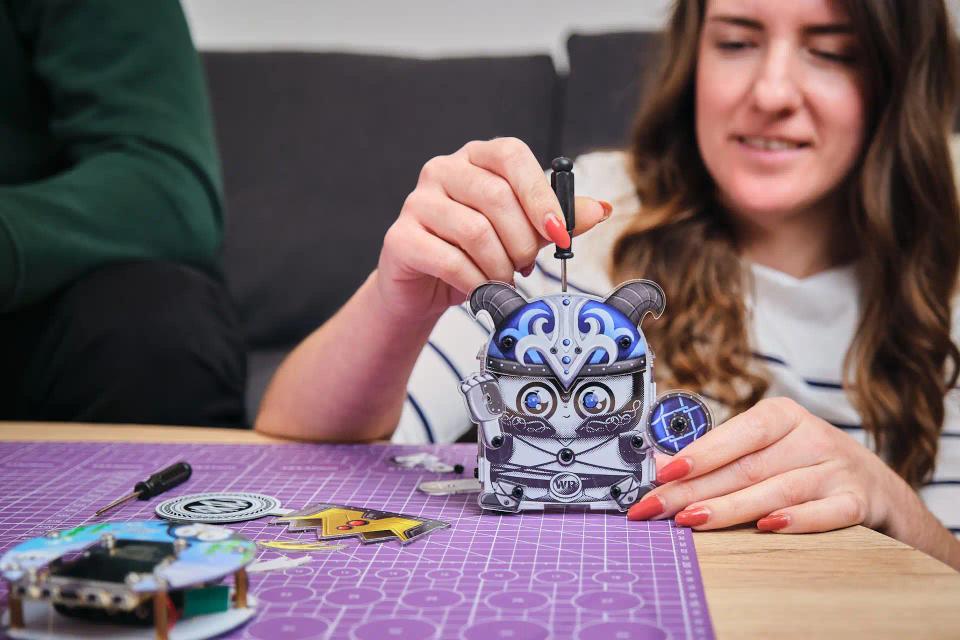 A woman assembling CircuitMess Harald
