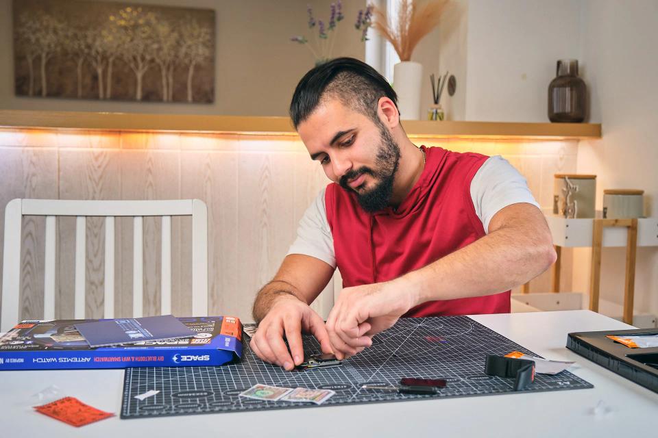 A man assembling CircuitMess NASA Artemis Watch