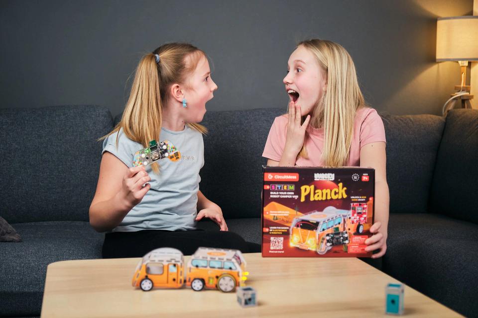 Two girls playing with CircuitMess Planck