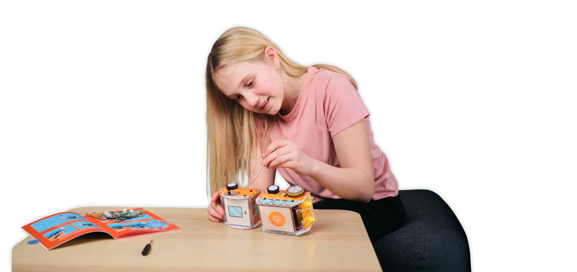 Girl using a screwdriver to assemble CircuitMess Planck
