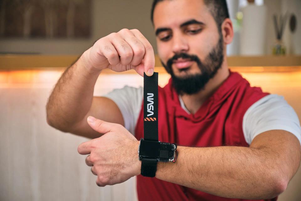 A man putting CircuitMess NASA Artemis Watch on his wrist