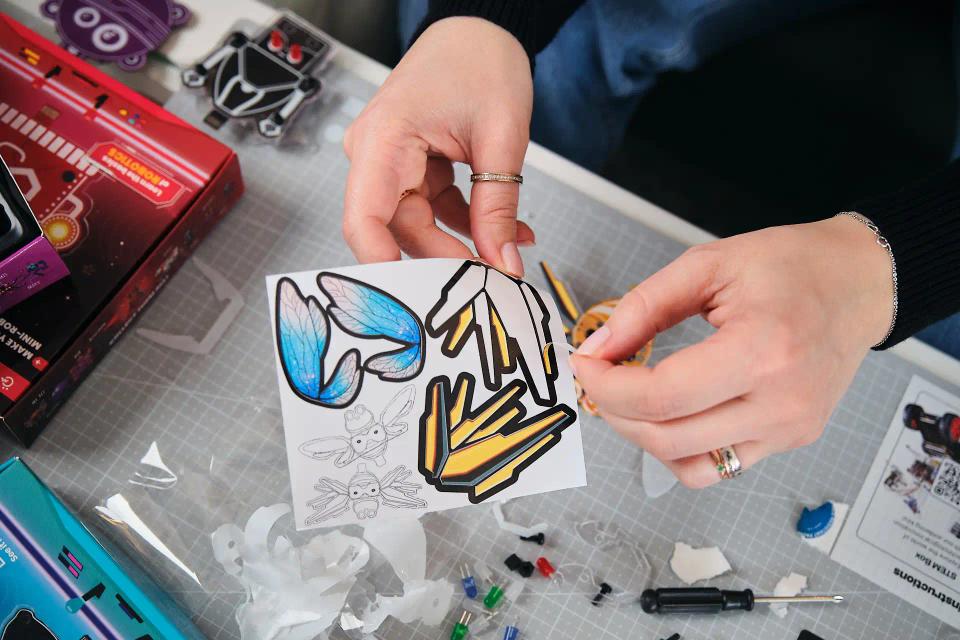 A person playing with CircuitMess Mr. Bee stickers