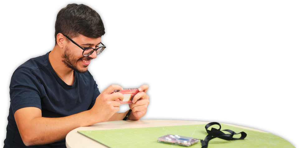 A man playing with CircuitMess ByteBoi 2.0.