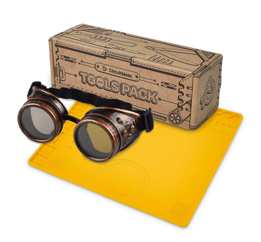 CircuitMess tools, silicon work mat and protective goggles on a transparent background