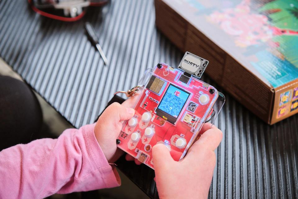 A person playing CircuitMess Bit with an unlocked Dusty secret game