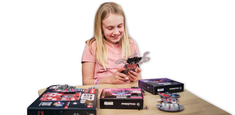 A girl playing with CircuitMess Bit and Artemis