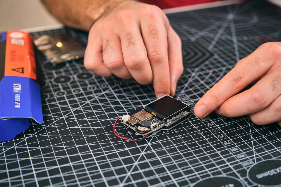 A person assembling CircuitMess NASA Artemis Watch