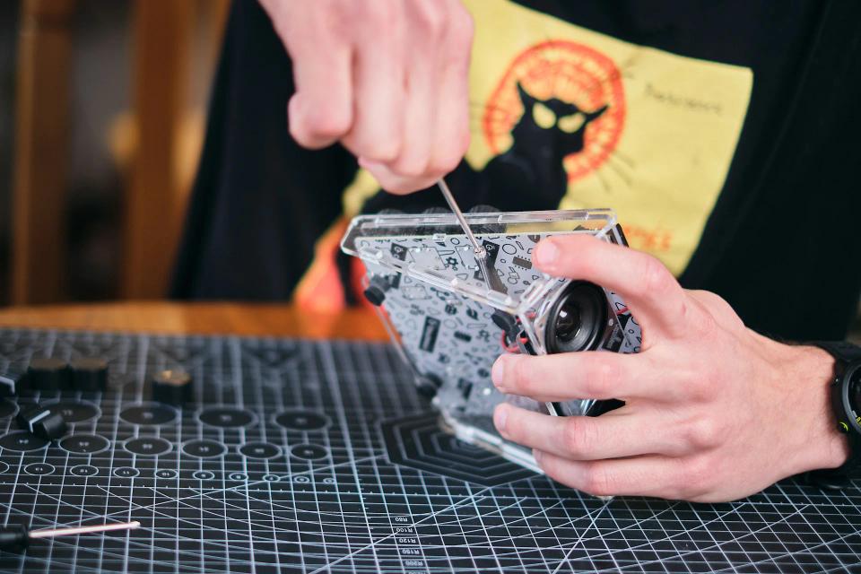 A person using a screwdriver to assemble CircuitMess Jay-D