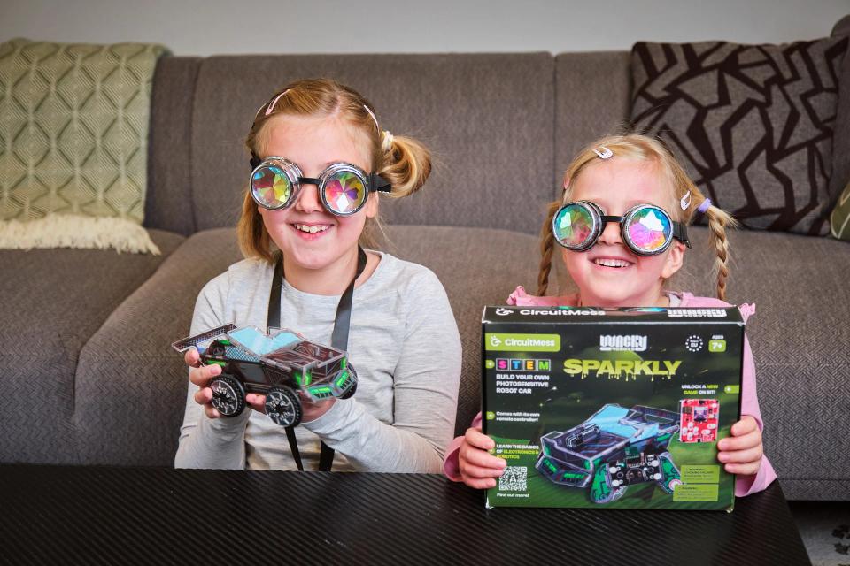 Two girls wearing Protective Goggles and holding CircuitMess Sparkly