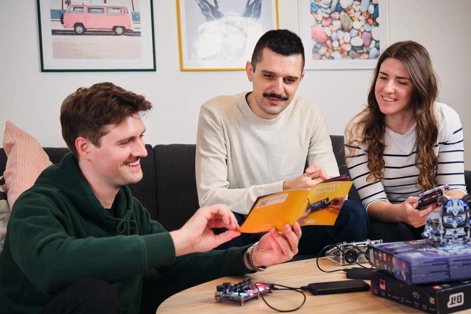 A group of people reading instructions and assembling CircuitMess Synthia, Jay-D, and Harald