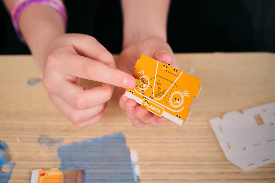 A person assembling CircuitMess Planck