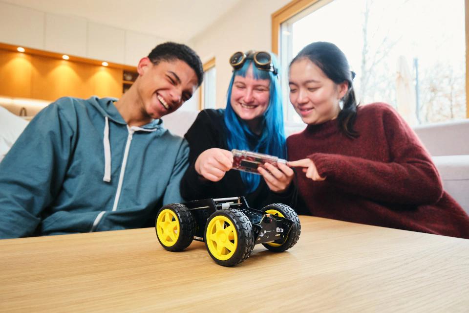 A group of people controlling CircuitMess Wheelson with ByteBoi