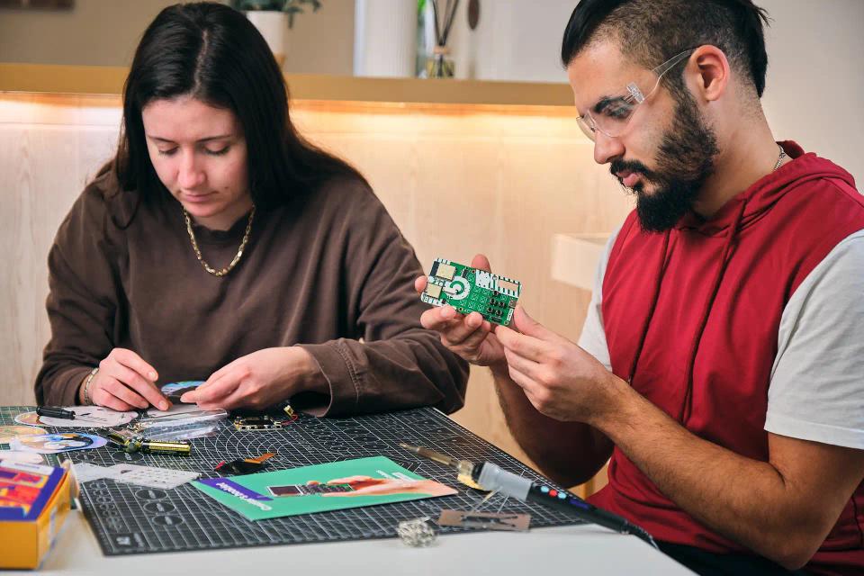 A woman and man assembling CircuitMess Chatter