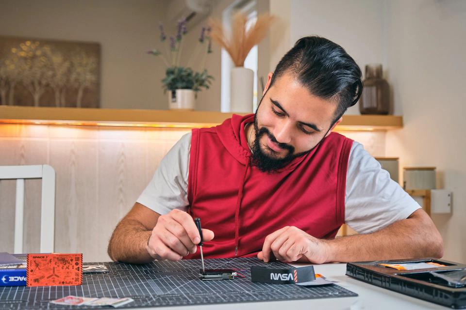 A man assembling CircuitMess NASA Artemis Watch