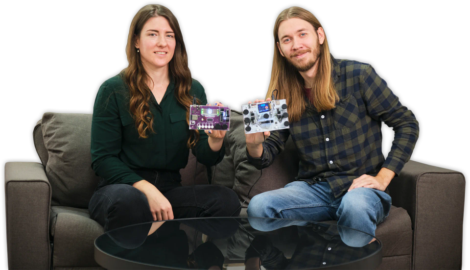 A man and a woman showing CircuitMess Synthia 2.0 and Jay-D 2.0.