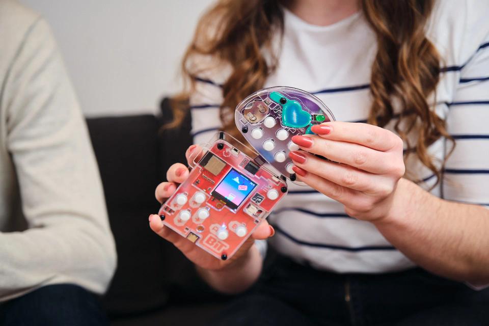 A woman attaching CircuitMess Buttons into Bit