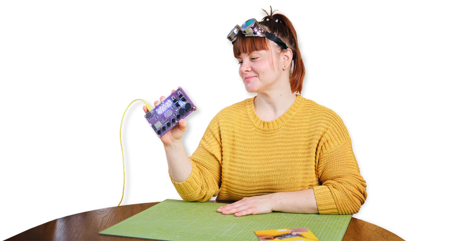 A woman holding CircuitMess Synthia