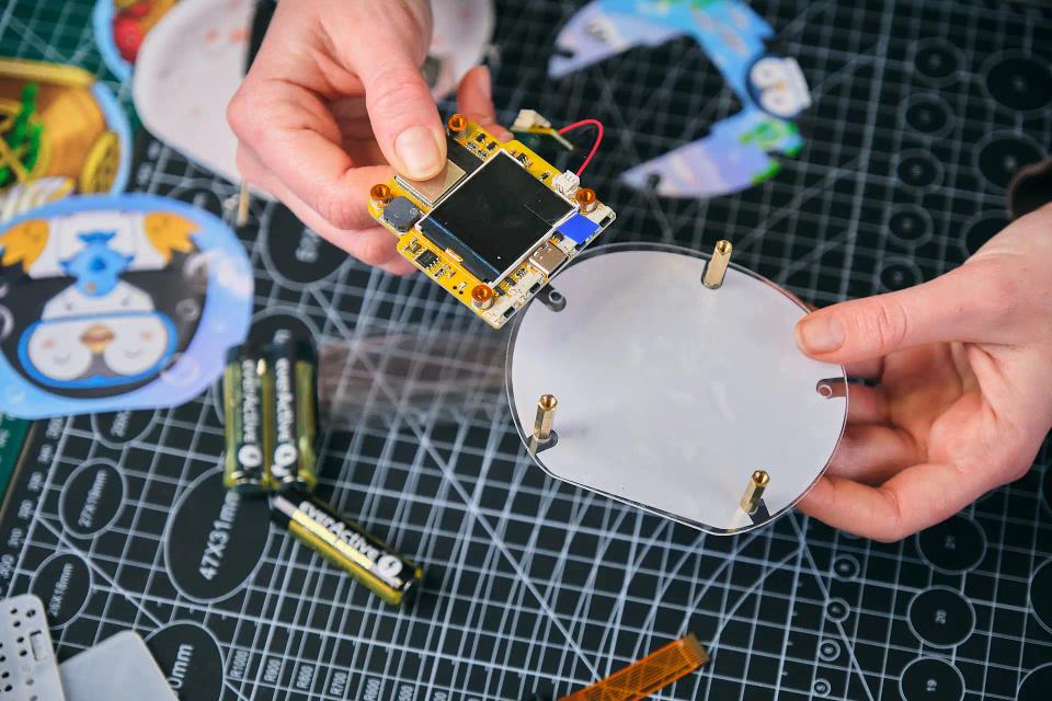 A person assembling CircuitMess Codee