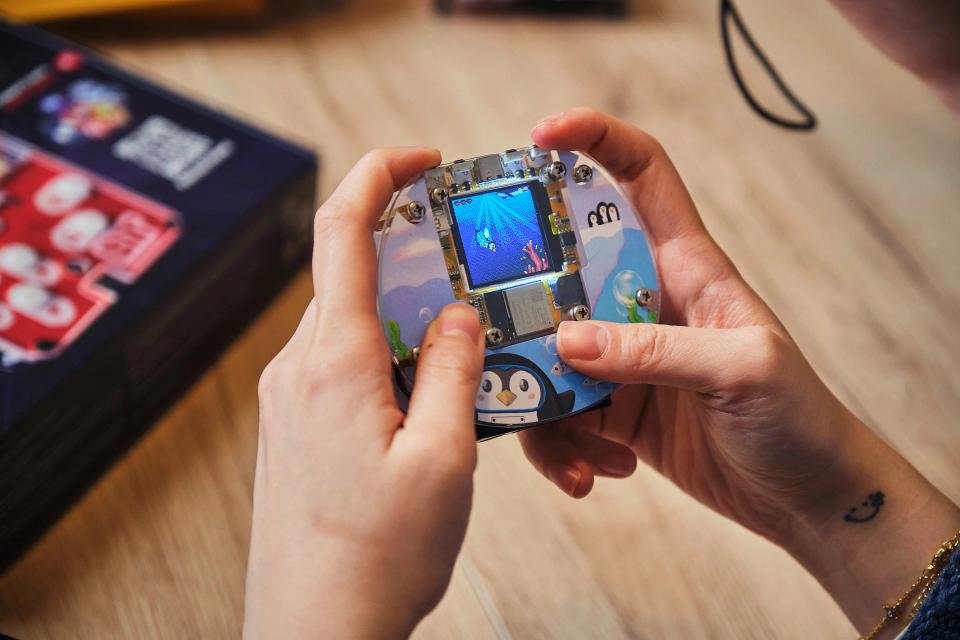 A person playing games on a CircuitMess Codee