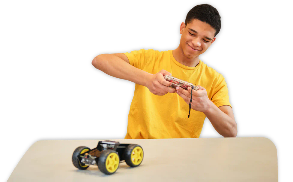 A man playing with CircuitMess Wheelson and ByteBoi