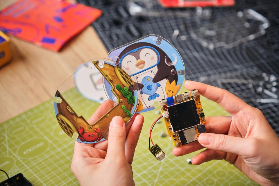 A person assembling CircuitMess Codee