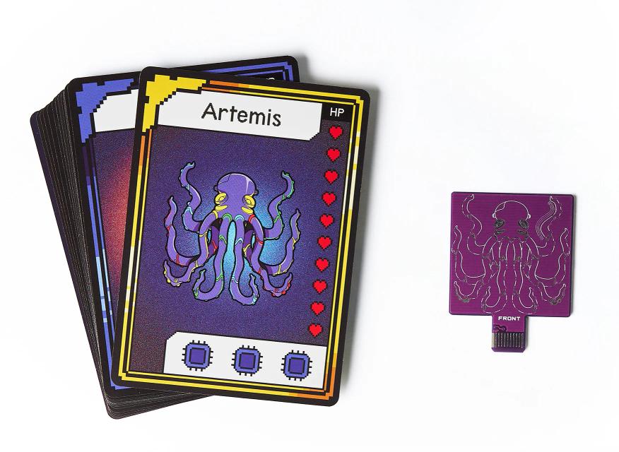 CircuitMess Bit Expansion Artemis cards and token on a white background.