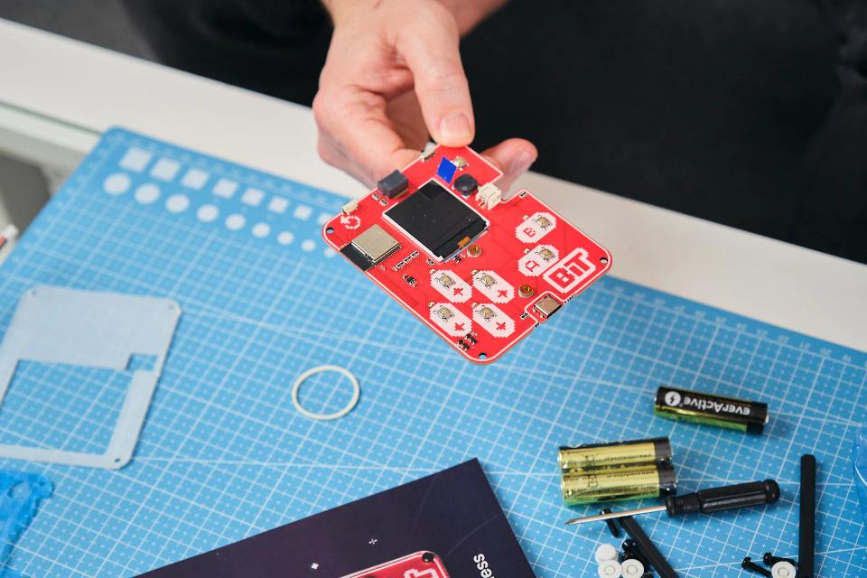 A person assembling CircuitMess Bit on a Silicone Work Mat
