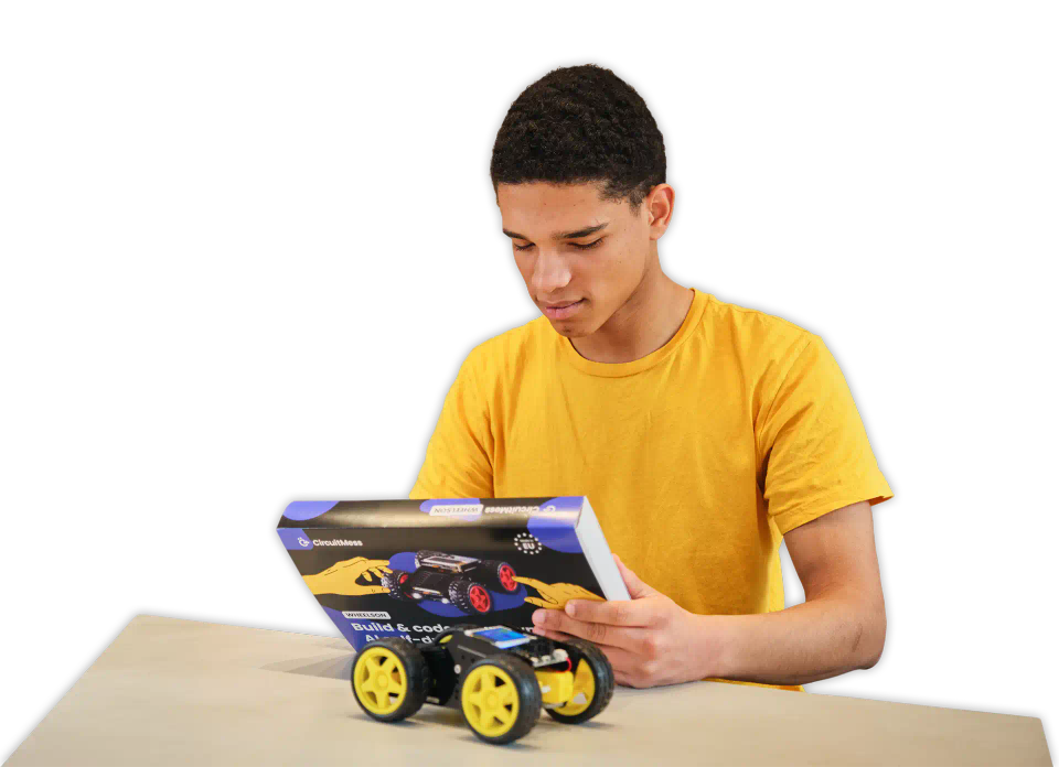 Man reading CircuitMess Wheelson packaging