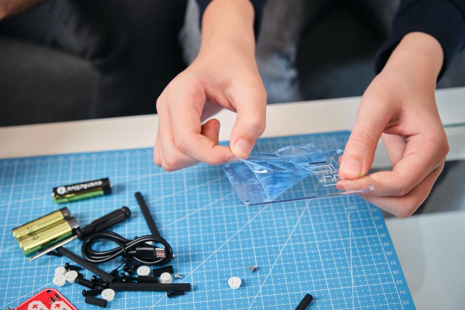 A person playing with CircuitMess Bit stickers
